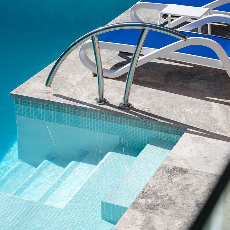 Silver Travertine Bullnose Pavers and Tumbled Pavers around Pool